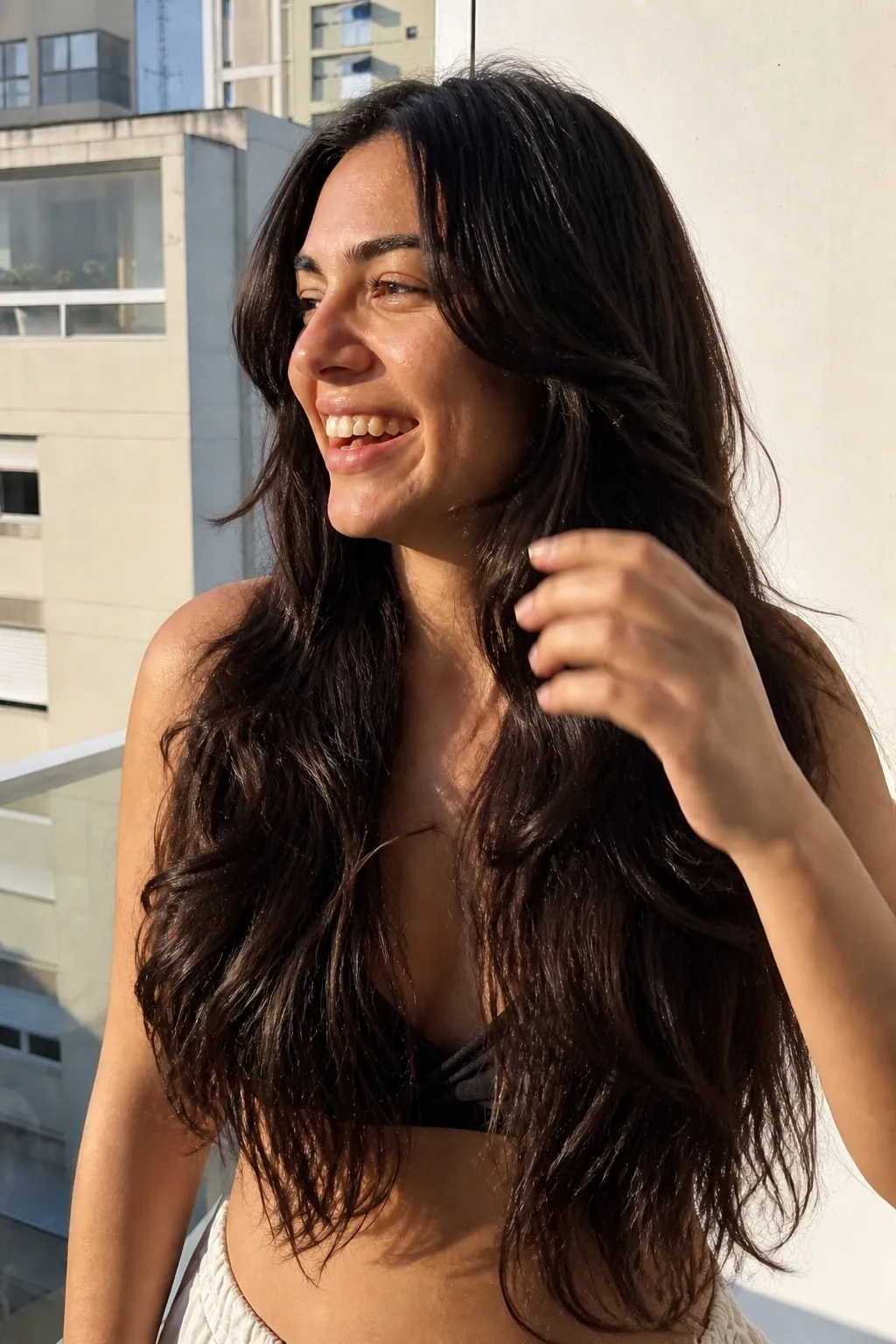 A woman on a sunny balcony before and after face-framing layers